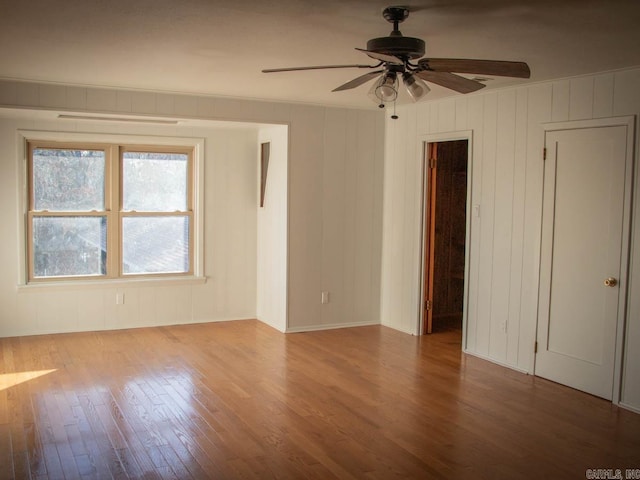 spare room with ceiling fan and wood-type flooring