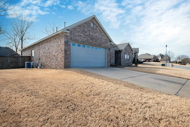 view of home's exterior featuring a garage, central AC unit, and a lawn