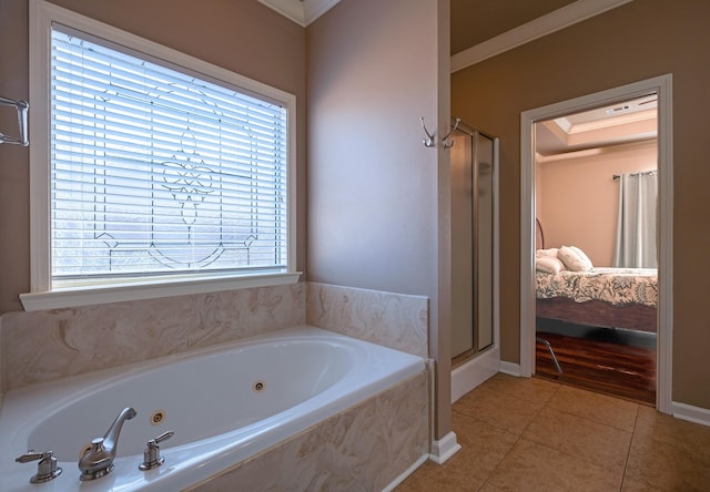 bathroom with plus walk in shower, a healthy amount of sunlight, tile patterned floors, and crown molding