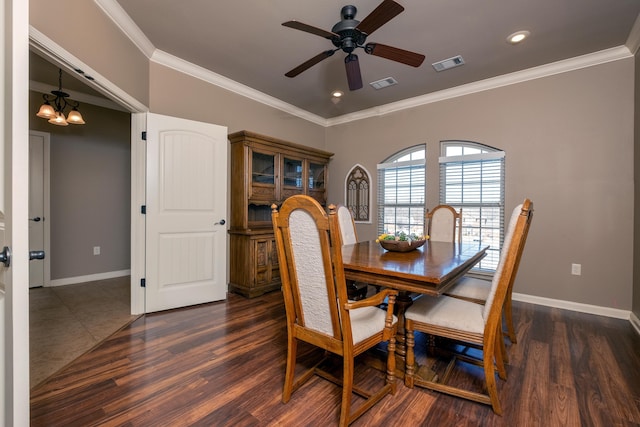 dining space with crown molding, ceiling fan with notable chandelier, and dark hardwood / wood-style floors