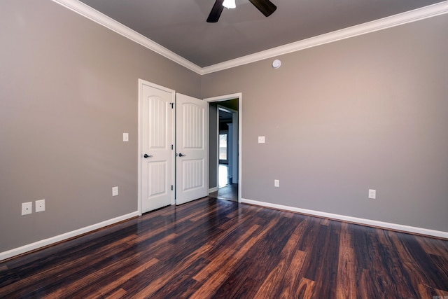 unfurnished room featuring ceiling fan, dark wood-type flooring, and ornamental molding