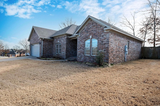 view of front facade with a garage and a front lawn