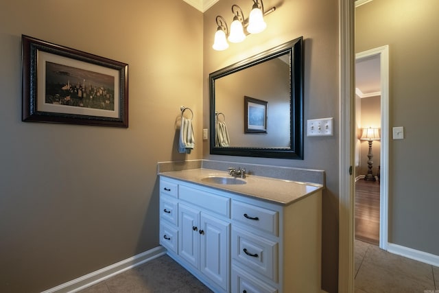 bathroom with tile patterned floors, vanity, and crown molding