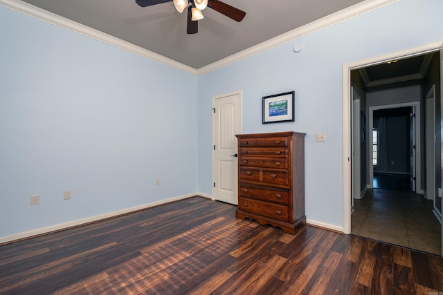 unfurnished bedroom with ceiling fan, ornamental molding, and dark hardwood / wood-style flooring