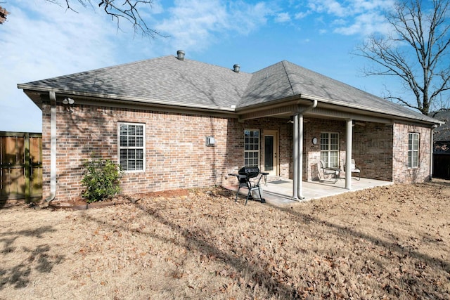 back of house featuring a patio area and a lawn