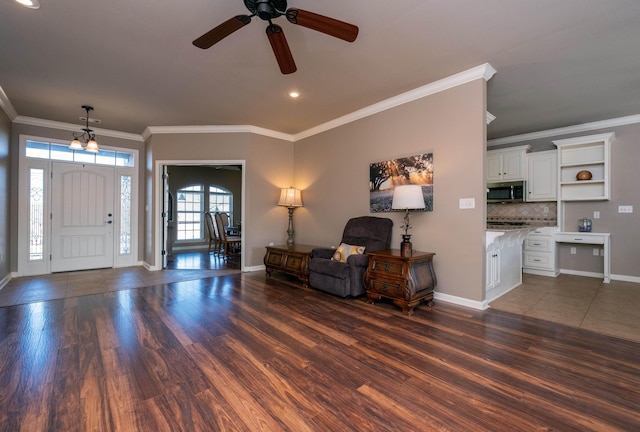 entrance foyer with ornamental molding and dark hardwood / wood-style floors