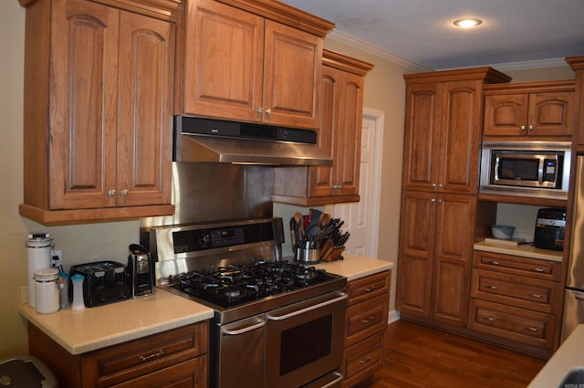 kitchen featuring stainless steel appliances, crown molding, and dark hardwood / wood-style flooring