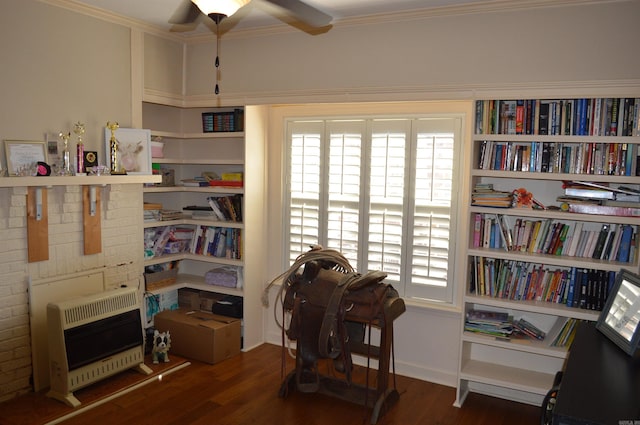 miscellaneous room featuring heating unit, ceiling fan, crown molding, and dark hardwood / wood-style flooring