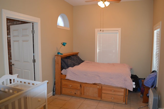 bedroom featuring ceiling fan and light tile patterned flooring