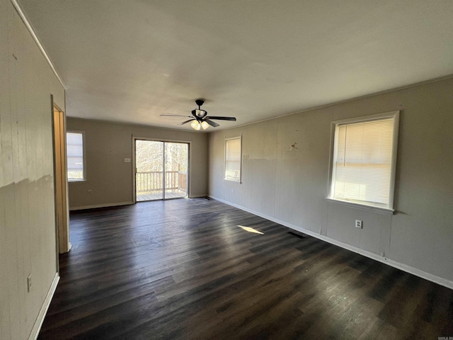 unfurnished room with dark wood-type flooring and ceiling fan