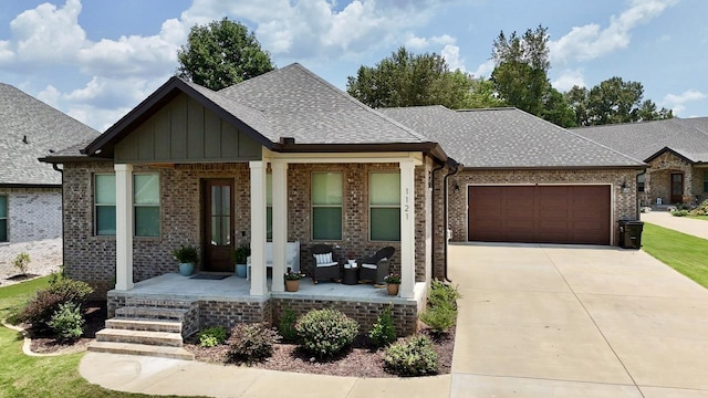 view of front of property featuring a porch and a garage