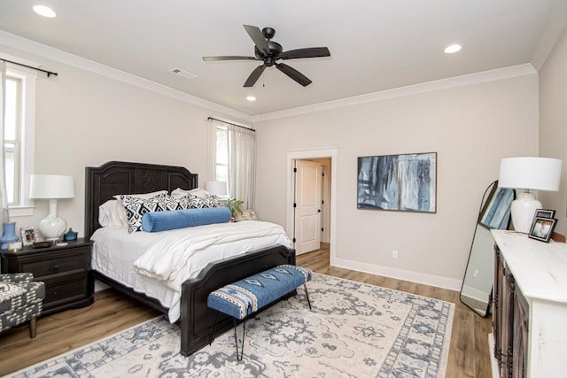 bedroom with ceiling fan, hardwood / wood-style floors, and crown molding