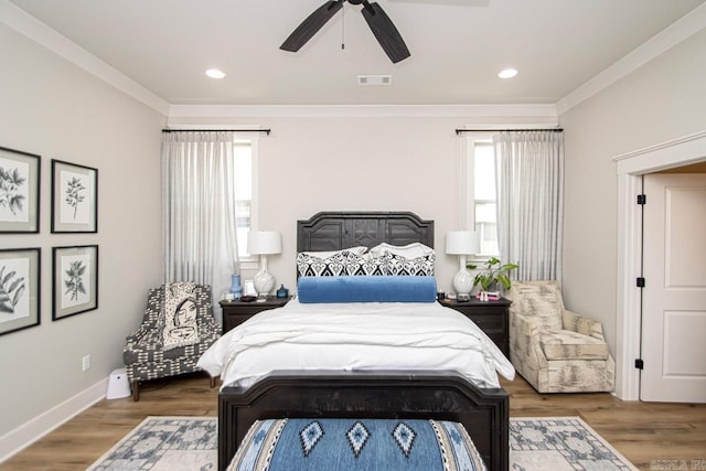 bedroom featuring ceiling fan, multiple windows, dark hardwood / wood-style flooring, and ornamental molding