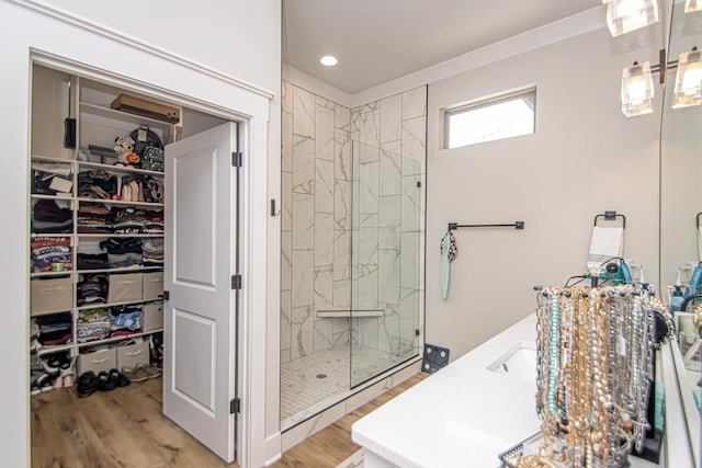 bathroom featuring vanity, a shower with shower door, and wood-type flooring