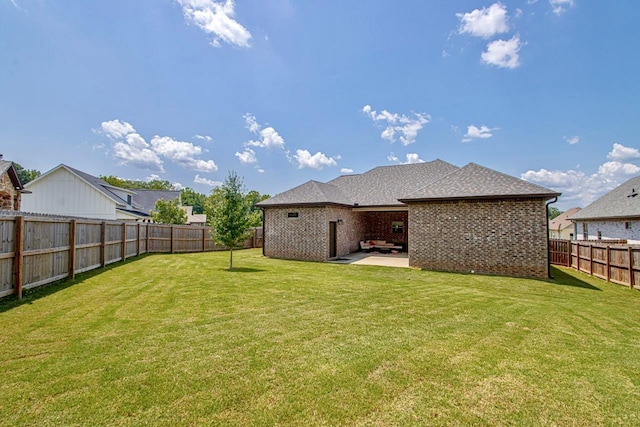 back of house featuring a patio area and a lawn