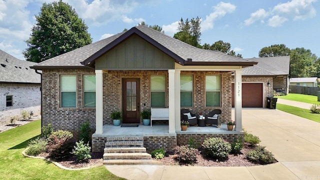 view of front of house featuring a porch and a garage