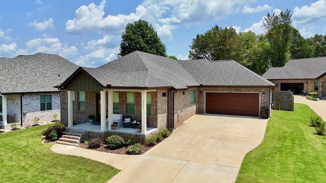 view of front of house featuring a garage, a front lawn, and a porch