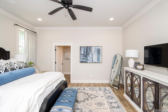 bedroom with ceiling fan, crown molding, and light hardwood / wood-style floors