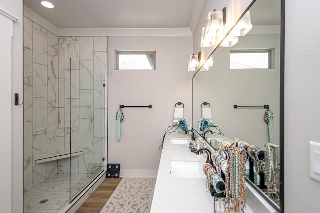 bathroom featuring hardwood / wood-style flooring, a wealth of natural light, an enclosed shower, and ornamental molding