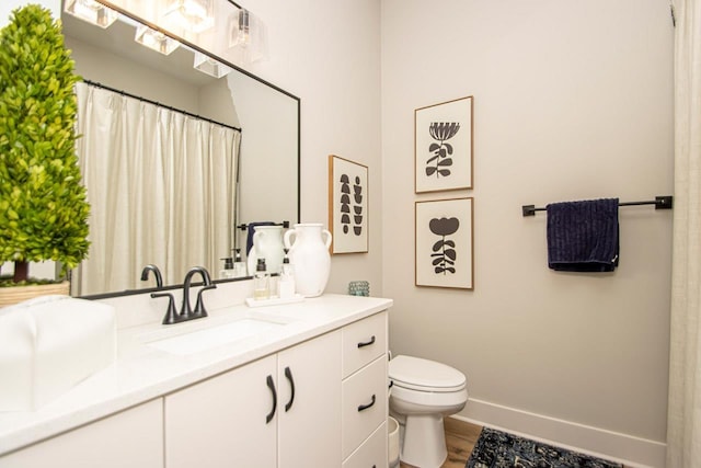 bathroom with toilet and vanity