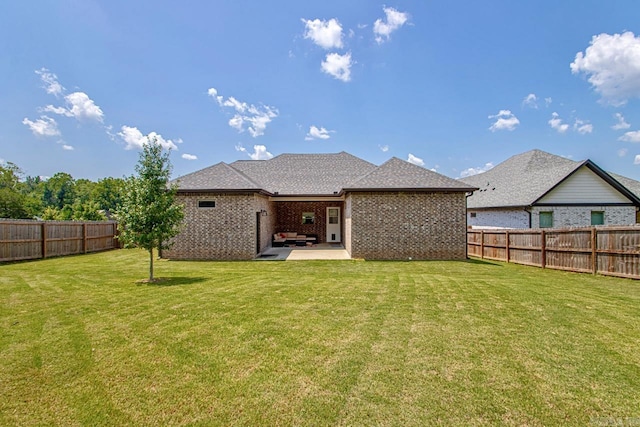 back of house featuring a patio area and a yard