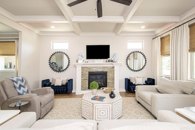 living room with coffered ceiling, light hardwood / wood-style flooring, beam ceiling, and a tile fireplace