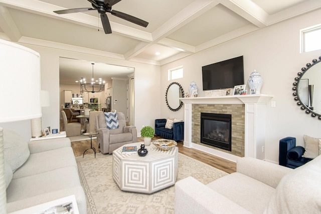 living room featuring coffered ceiling, beamed ceiling, light hardwood / wood-style flooring, and a wealth of natural light