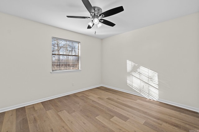 spare room with ceiling fan and light wood-type flooring