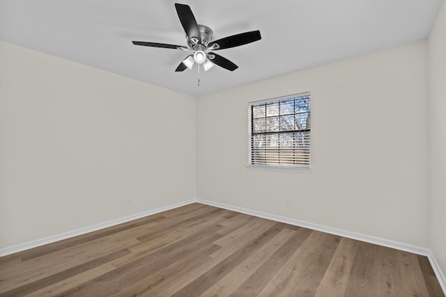 spare room with hardwood / wood-style floors and ceiling fan