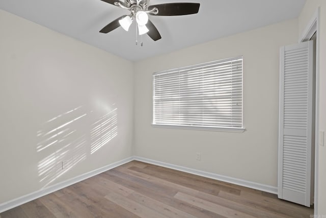 empty room with light wood-type flooring and ceiling fan