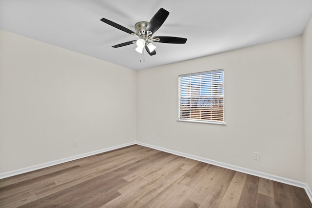 spare room with light hardwood / wood-style flooring and ceiling fan