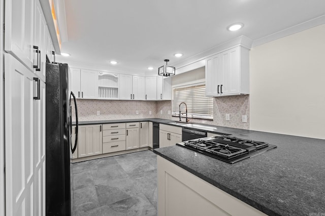 kitchen featuring black appliances, white cabinets, decorative backsplash, and sink