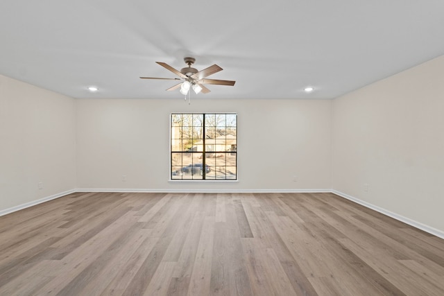 spare room featuring light wood-type flooring and ceiling fan