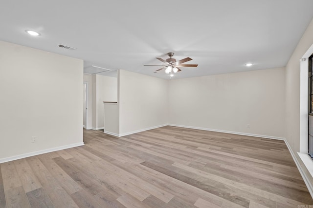 empty room with light hardwood / wood-style floors and ceiling fan