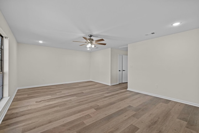 spare room featuring ceiling fan and light wood-type flooring