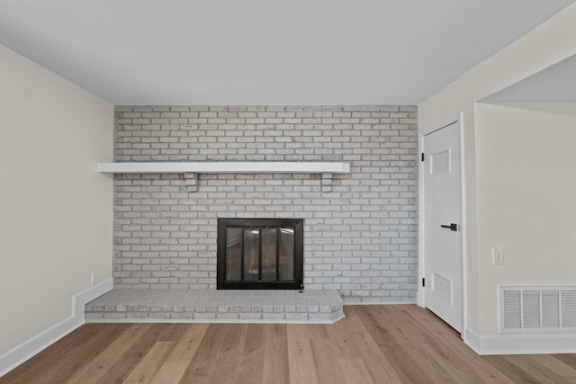 unfurnished living room featuring light hardwood / wood-style flooring and a fireplace