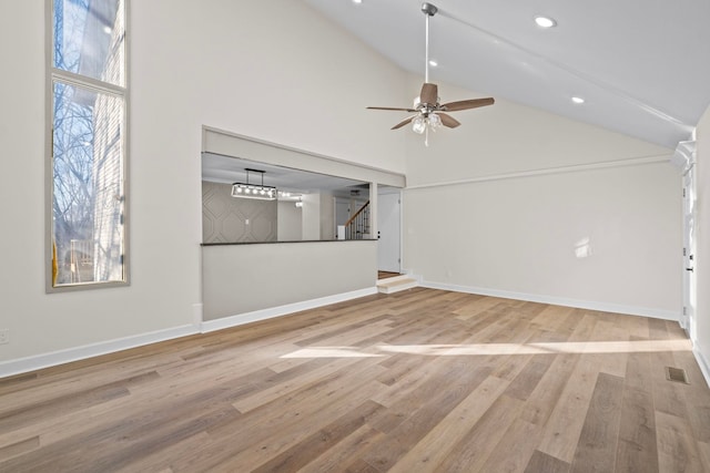 unfurnished living room with high vaulted ceiling, hardwood / wood-style flooring, and ceiling fan