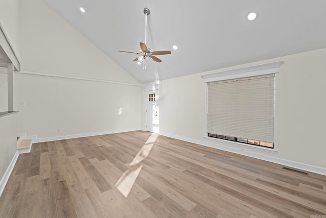 unfurnished living room with high vaulted ceiling, light hardwood / wood-style floors, and ceiling fan