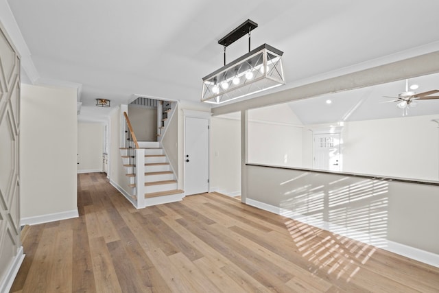 entryway with wood-type flooring, ceiling fan, and lofted ceiling