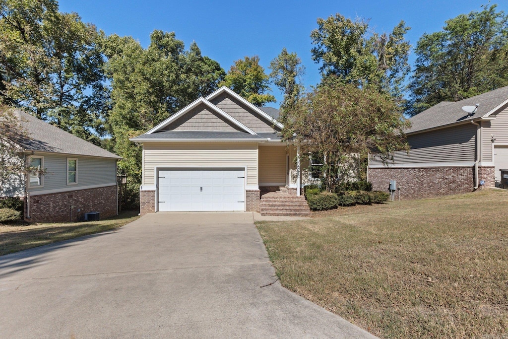 view of front of house featuring a garage and a front lawn