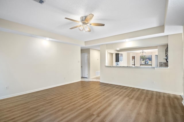 unfurnished living room with ceiling fan, a textured ceiling, and hardwood / wood-style flooring