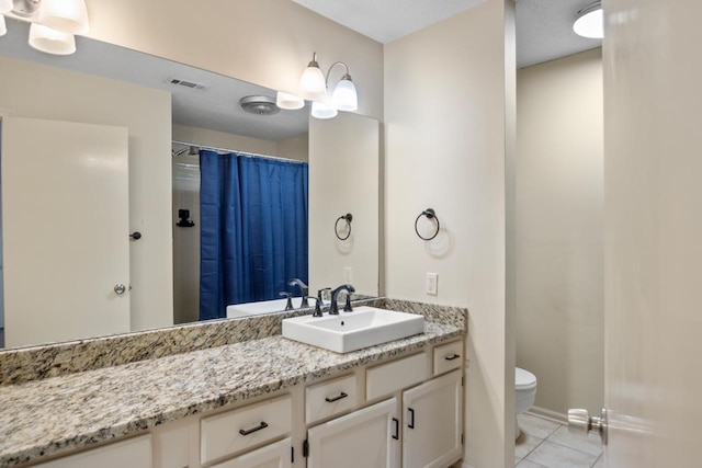 bathroom featuring vanity, toilet, tile patterned floors, and a shower with shower curtain