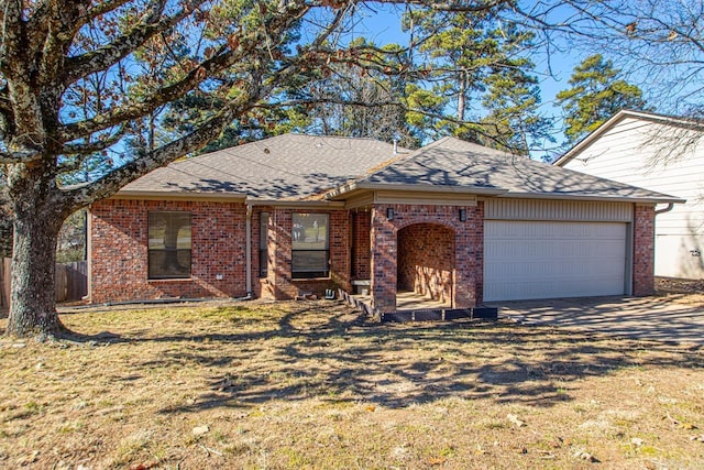 single story home with a garage and a front lawn