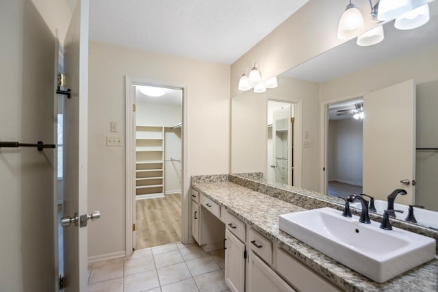 bathroom with vanity, tile patterned floors, and a textured ceiling