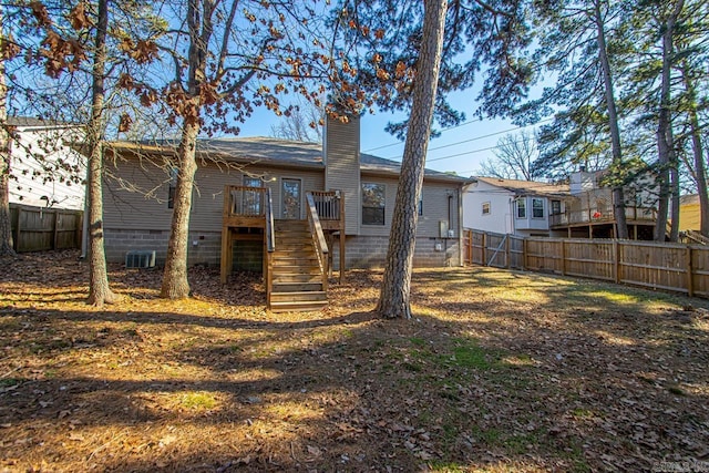 rear view of property featuring a wooden deck and central air condition unit