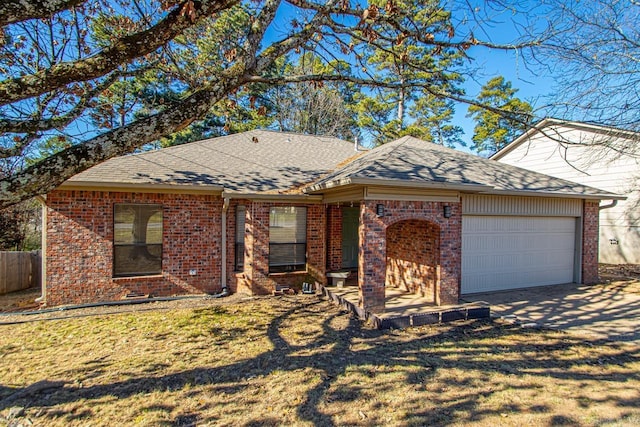 ranch-style house featuring a garage and a front lawn