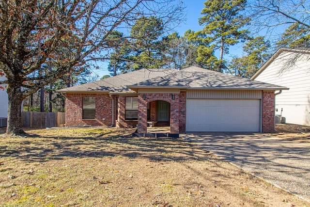 ranch-style home featuring a garage and a front lawn