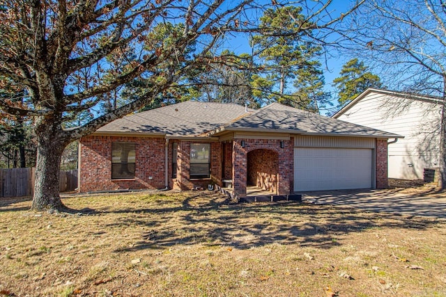 ranch-style house featuring a garage and a front yard