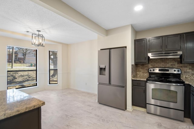 kitchen featuring tasteful backsplash, pendant lighting, light stone countertops, and appliances with stainless steel finishes