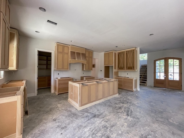 19100 Waterview Meadow Ln, Roland, AR 72135 - kitchen with a center island, french doors, light brown cabinetry, baseboards, and premium range hood